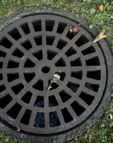 How To Disguise Raised Drain Covers In Garden